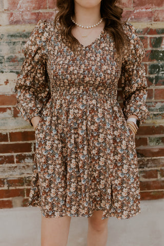 Model wearing vintage floral smocked dress.