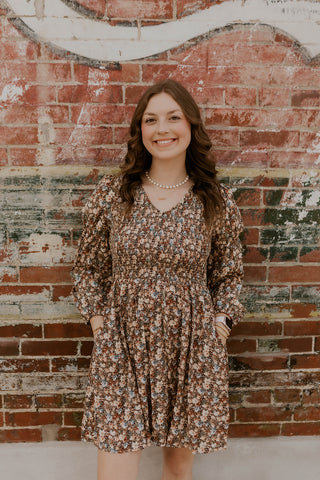 Model wearing vintage floral smocked dress.