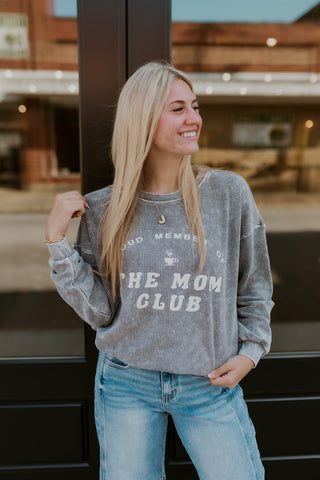 Model wearing ribbed sweatshirt stating "Proud Member of the Moms Club"